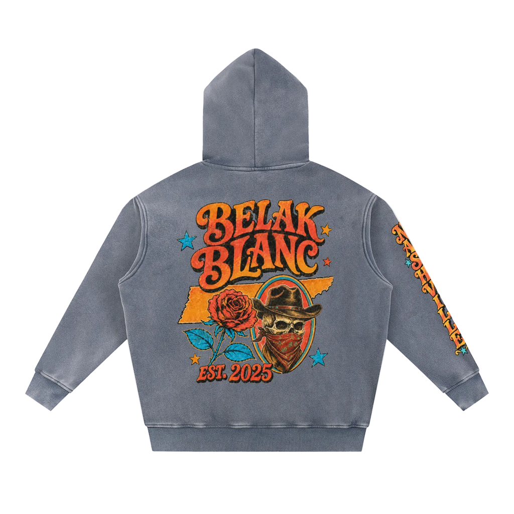 A washed slate blue-gray pullover hoodie with a small embroidered red rose on the left chest and a colorful floral pattern down the right sleeve, shown on a plain white background.