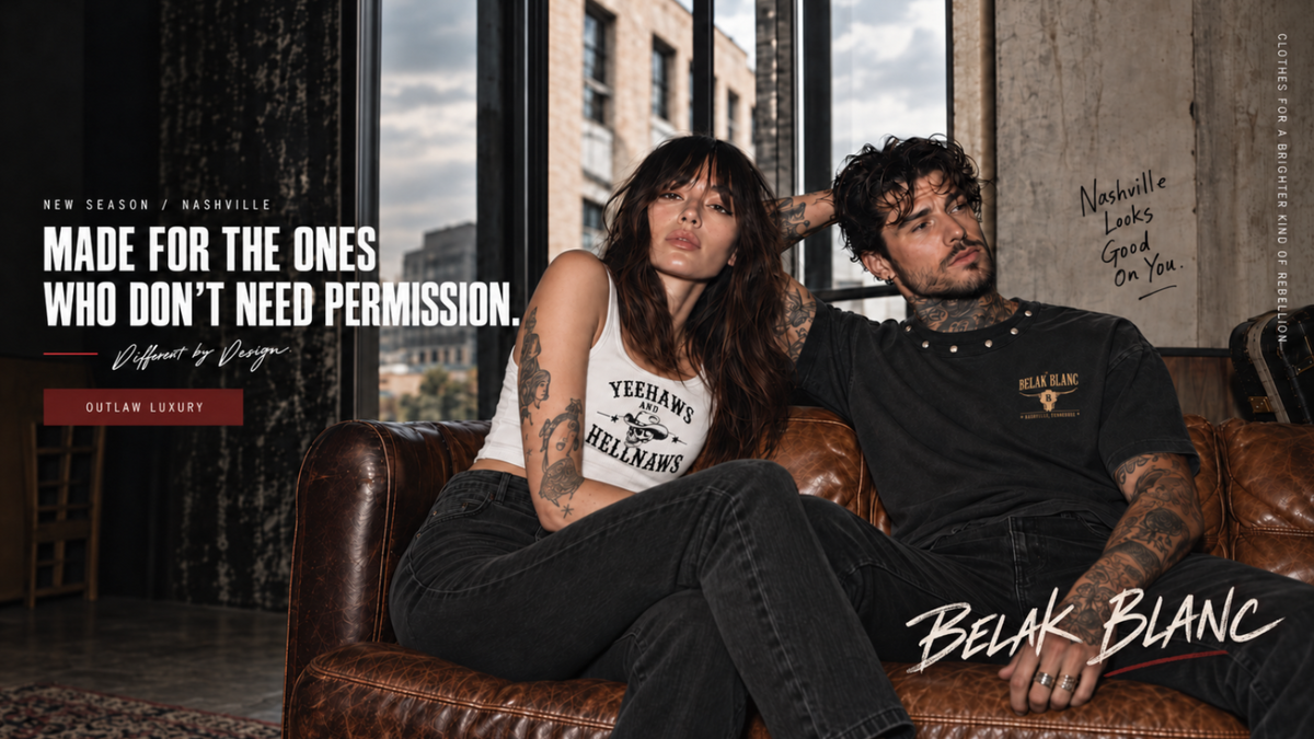 A promotional lifestyle photo featuring a man and woman sitting on a brown leather couch in a loft-style room. The woman wears a white tank top with 'Yeehaw! Hellansars' text and black jeans, while the man wears a black t-shirt with a small gold logo.